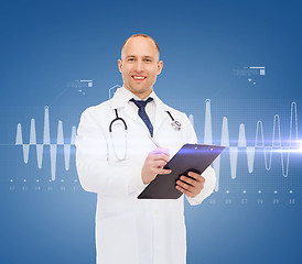 Image showing smiling male doctor with clipboard and stethoscope