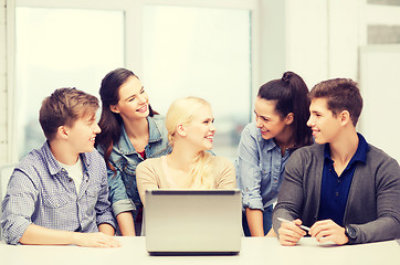 Image showing smiling students with laptop at school