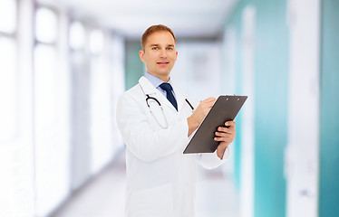 Image showing smiling male doctor with clipboard and stethoscope