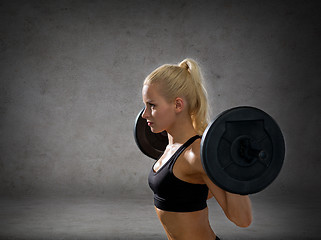 Image showing sporty woman exercising with barbell