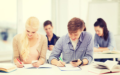 Image showing students looking into smartphone at school