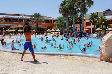 Image showing Tourists on holiday are doing water aerobics in pool