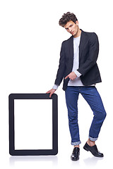 Image showing Full length man holding empty frame