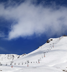 Image showing Chair-lift and ski slope in sun day