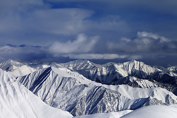 Image showing Sunlight snowy mountains and storm clouds