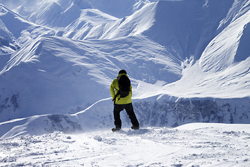 Image showing Snowboarder on top of off-piste slope at windy day