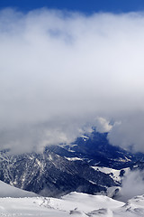 Image showing Winter snowy mountains in clouds