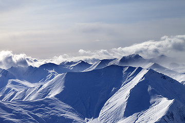 Image showing Evening snowy mountains in mist