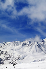 Image showing Winter snowy mountains and ski slope