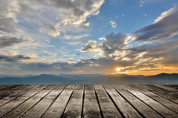 Image showing City sunset with wooden ground