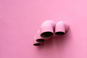 Image showing Pink pipes on wall