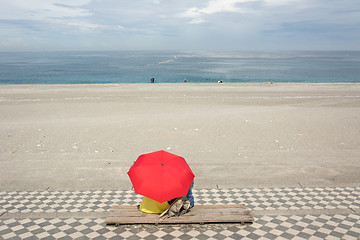 Image showing Couple on beach under umbrella