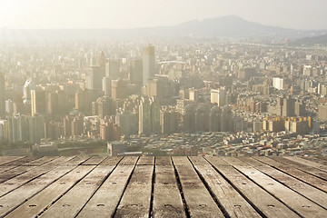 Image showing City sunset with wooden ground