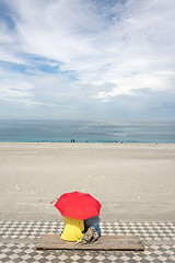 Image showing Couple on beach under umbrella