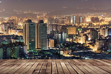 Image showing City night scene with wooden ground