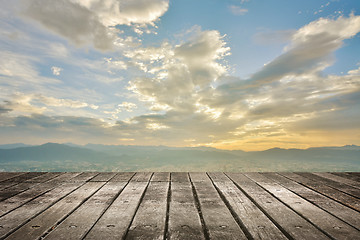 Image showing City sunset with wooden ground