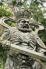 Image showing Aged asian god statue