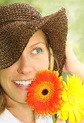 Image showing attractive girl with straw hat and daisies