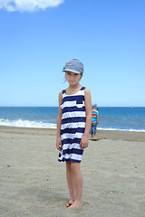 Image showing Serious cute little girl on the beach