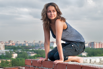 Image showing Attractive girl on roof