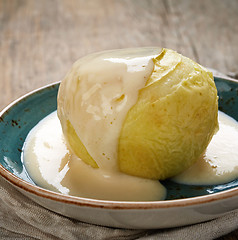 Image showing baked apple with vanilla sauce