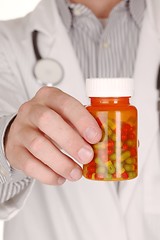 Image showing Doctor With Medication in Prescription Bottles