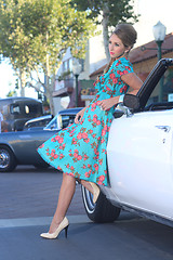 Image showing Lovely Woman Posing and and Around a Vintage Car