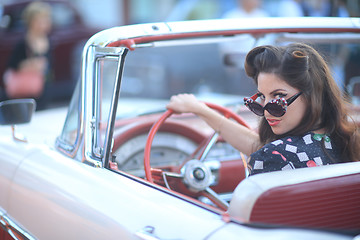 Image showing Lovely Woman Posing and and Around a Vintage Car