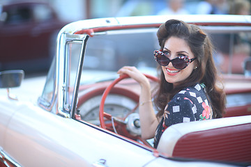 Image showing Lovely Woman Posing and and Around a Vintage Car