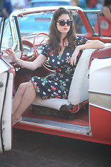 Image showing Lovely Woman Posing and and Around a Vintage Car