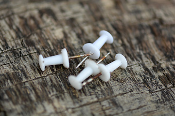 Image showing Set of old white pins on wood background