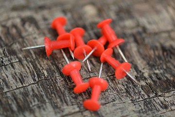 Image showing Set of old red pins on wood background