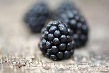 Image showing Ripe blackberry on a wooden background