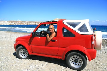 Image showing Man in red jeep