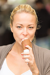 Image showing Lady licking icecream.