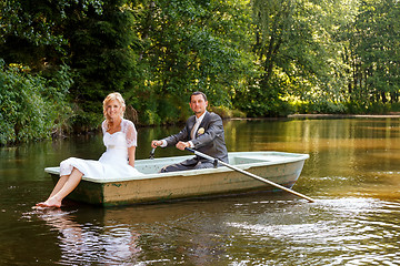 Image showing Young just married bride and groom on boat