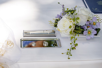 Image showing Wedding rings and flower decoration