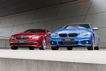 Image showing Red 640i and blue 425d wet after rain BWM autos