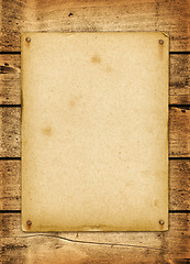 Image showing Blank vintage poster nailed on a wood board