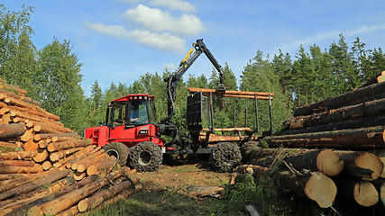 Image showing Operator Stacking up Logs with Komatsu 830.3 Forestry Forwarder