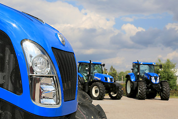 Image showing Group of New Holland Agricultural Tractors on Display