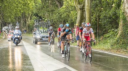 Image showing Group of Cyclists in a Rainy Day