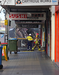 Image showing Fire Search and Rescue begin searching the remains of a shop aft