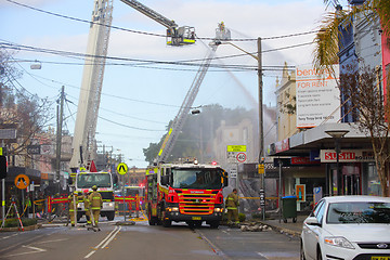 Image showing Firemen douse flames after explosion at a convenience store in R