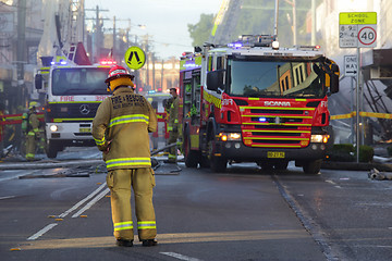 Image showing Firefighters and rescue crew attend shop blast