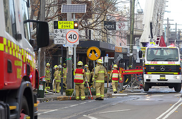 Image showing Fire crew and engineers at work at site of explosion