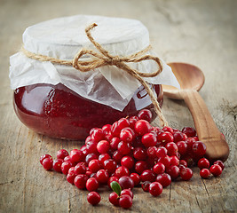 Image showing fresh raw cowberries and jar of jam