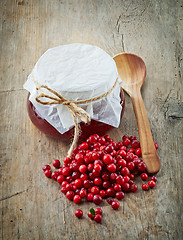 Image showing fresh raw cowberries and jar of jam