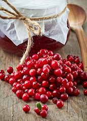 Image showing fresh raw cowberries and jar of jam