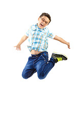 Image showing happy little boy jumping on withe